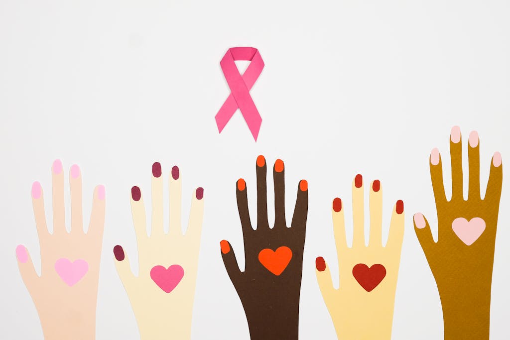 Creative representation of diversity with hands and pink ribbon symbolizing breast cancer awareness.